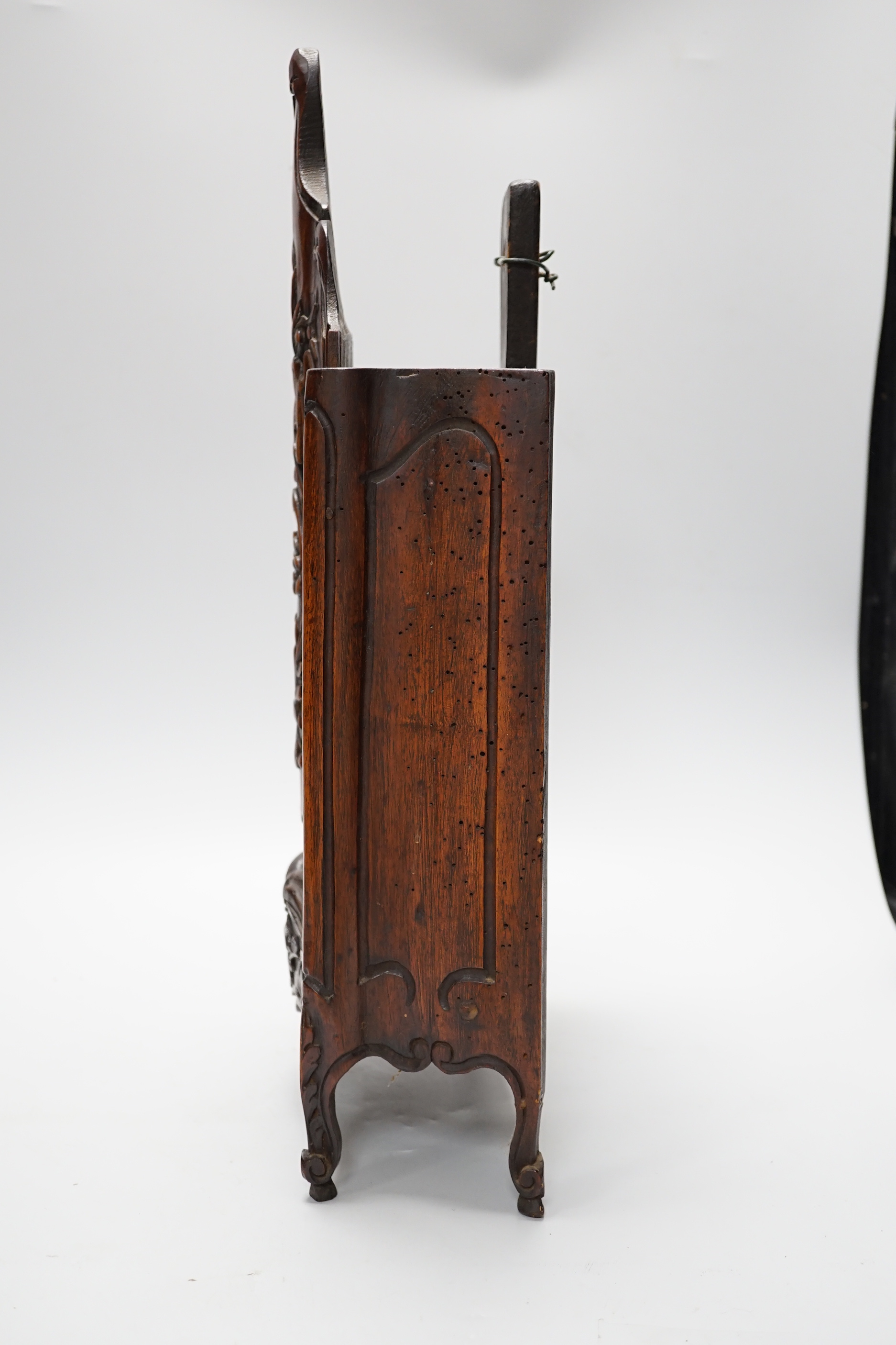 An 18th century French carved walnut miniature armoire/hutch with sliding front panel, 50cm high